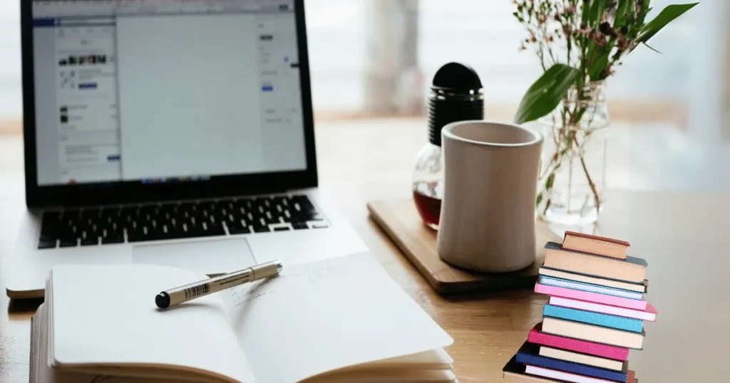 A bundle of books with and a computer for study